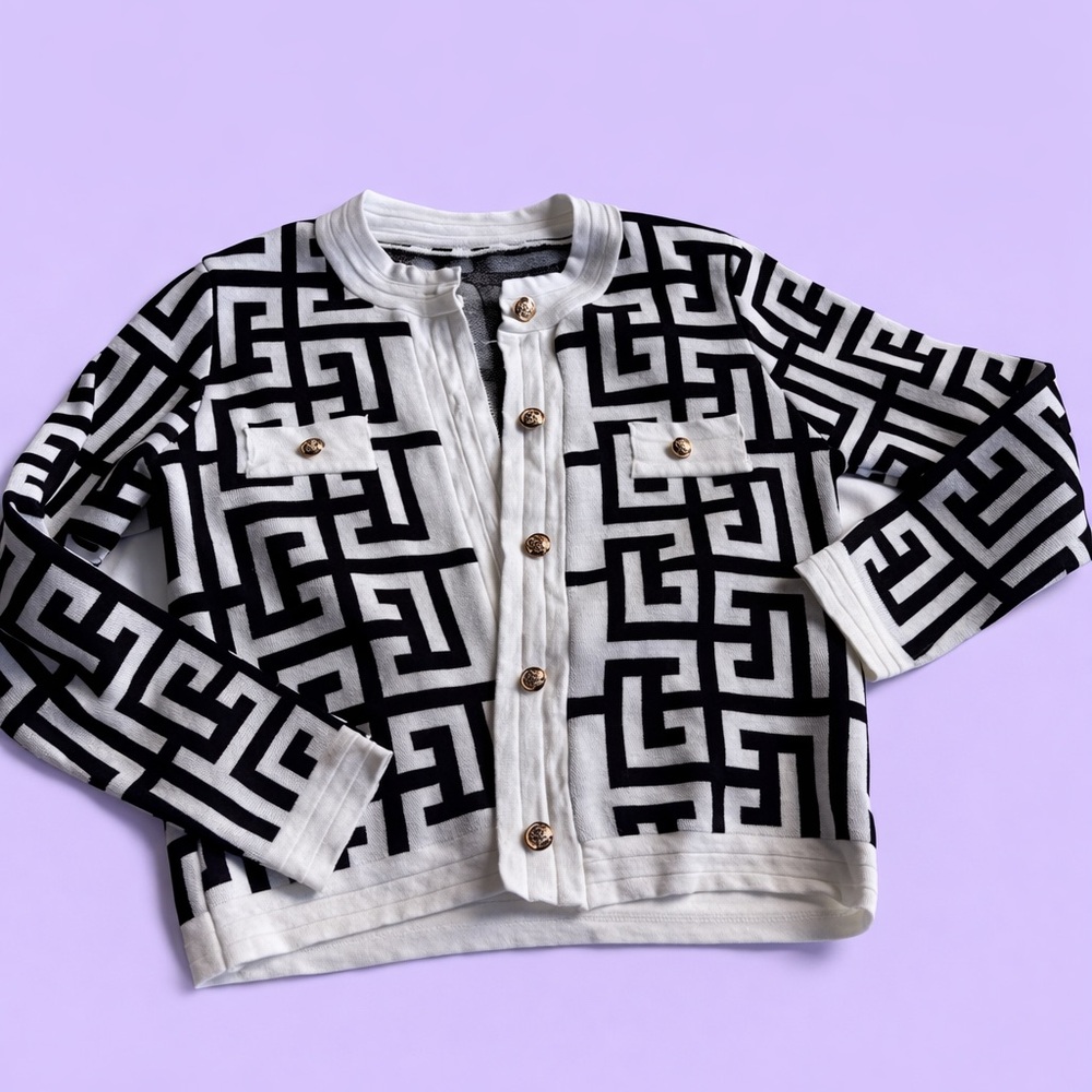 Black and white geometrical patterned cardigan with gold buttons